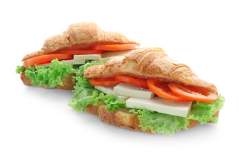 Tasty croissant sandwiches on white background