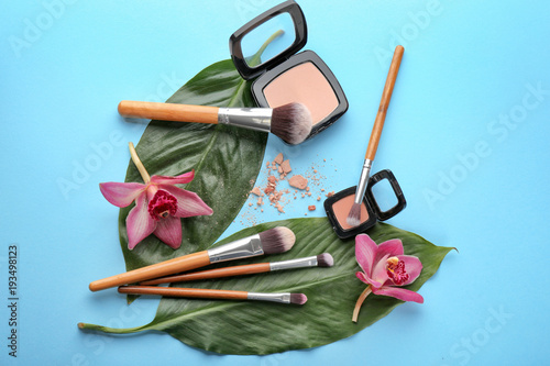Cosmetics And Tools Of Professional Makeup Artist With Floral