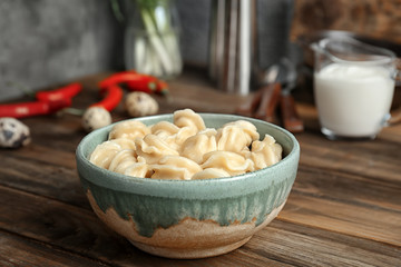 Bowl with tasty meat dumplings on table