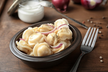 Bowl with tasty meat dumplings on table