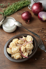 Bowl with tasty meat dumplings on table