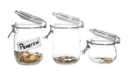 Glass jars with coins and tag PENSION on white background