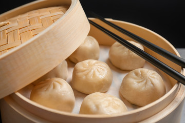 Bamboo steamer with tasty baozi dumplings, closeup