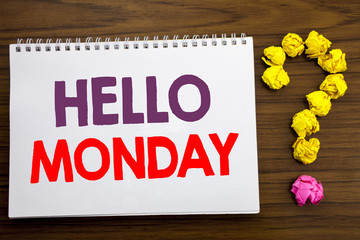 Fototapeta premium Conceptual hand writing caption inspiration showing Hello Monday. Business concept for Day Week Start written on notepad note paper on the wooden background with question mark.