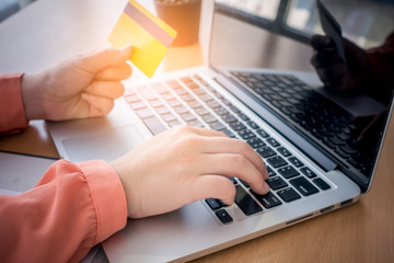 woman hands holding laptop and using credit card for online shopping.Online shopping concept.