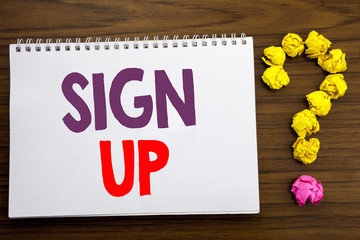 Fototapeta premium Conceptual hand writing caption inspiration showing Sign Up. Business concept for Member Register Registration written on notepad note paper on the wooden background with question mark.