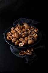 Beautifully presented walnuts on dark slate plate kitchen with napkin table can be used as background