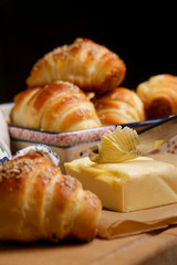 Freshly baked croissants and butter on the table