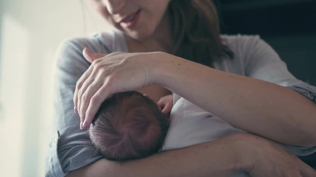 Mother breastfeeding her little baby girl