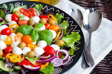 Greek salad with fresh vegetables, feta cheese and black olives