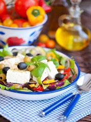 Greek salad with fresh vegetables, feta cheese and black olives