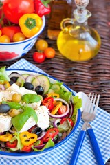 Fototapeta na wymiar Greek salad with fresh vegetables, feta cheese and black olives
