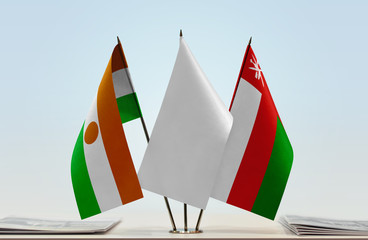 Flags of Niger and Oman with a white flag in the middle