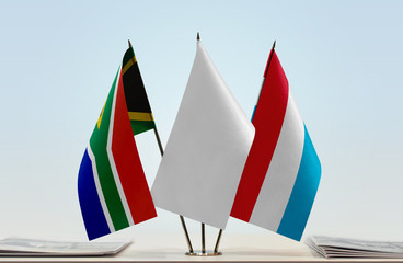 Flags of Republic of South Africa and Luxembourg with a white flag in the middle