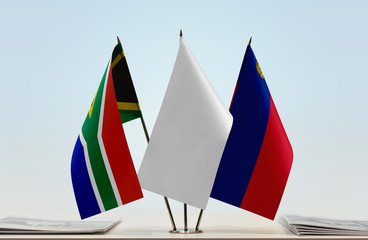 Flags of Republic of South Africa and Liechtenstein with a white flag in the middle