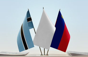 Flags of Botswana and Liechtenstein with a white flag in the middle