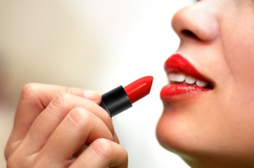 Women put on red lipstick