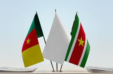 Flags of Cameron and Suriname with a white flag in the middle