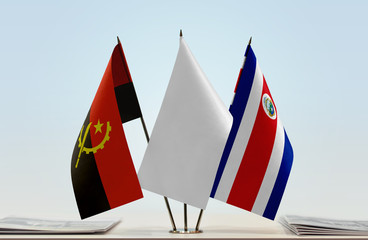 Flags of Angola and Costa Rica with a white flag in the middle