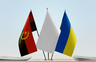 Flags of Angola and Ukraine with a white flag in the middle