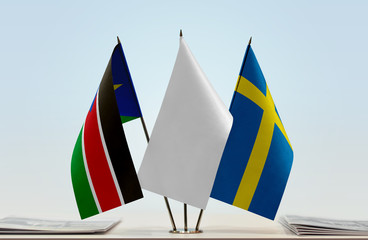 Flags of South Sudan and Sweden with a white flag in the middle