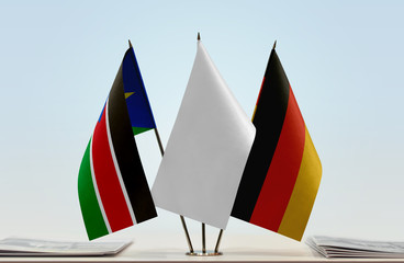 Flags of South Sudan and Germany with a white flag in the middle