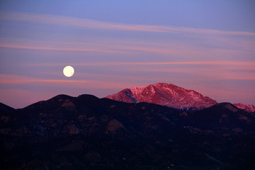 Full moon over the mountains at the lake in Colorado