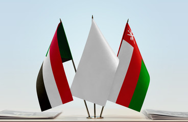 Flags of Sudan and Oman with a white flag in the middle