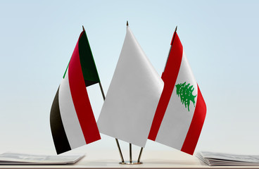 Flags of Sudan and Lebanon with a white flag in the middle