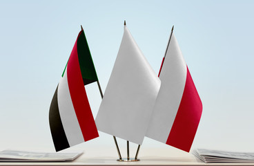 Flags of Sudan and Poland with a white flag in the middle
