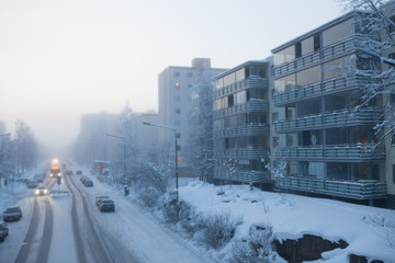 Small city street at cold foggy winter day