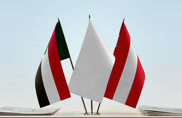 Flags of Sudan and Austria with a white flag in the middle
