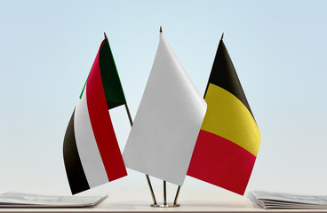 Flags of Sudan and Belgium with a white flag in the middle