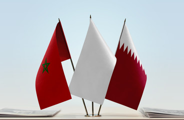 Fototapeta na wymiar Flags of Morocco and Qatar with a white flag in the middle