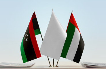 Flags of Libya and UAE with a white flag in the middle