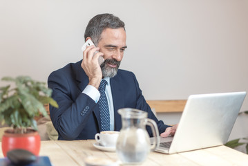 Elderly business man in a coffee shop