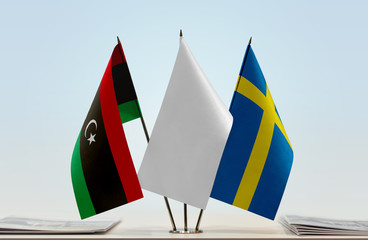 Flags of Libya and Sweden with a white flag in the middle