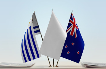 Flags of Uruguay and New Zealand with a white flag in the middle