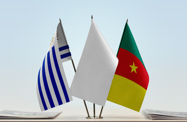 Flags of Uruguay and Cameroon with a white flag in the middle