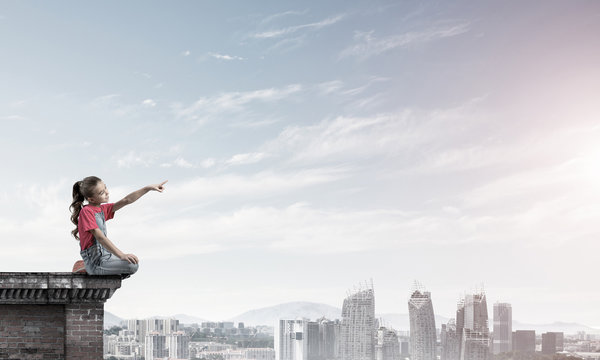 Concept of careless happy childhood with girl showing touch gest