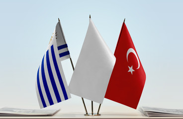 Flags of Uruguay and Turkey with a white flag in the middle