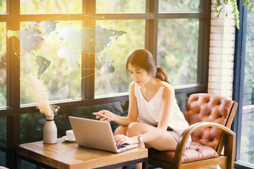 Asian business woman hand working with modern technology laptop and digital layer effect as business strategy concept Global network connection ,m-banking marketing and internet of things(IOT)