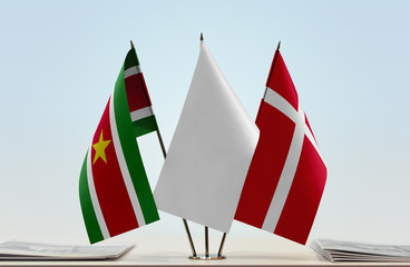 Flags of Suriname and Denmark with a white flag in the middle