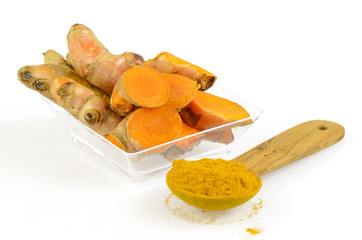 Turmeric roots and turmeric power on white background.