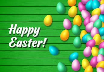 Easter frame with shiny colorful happy eggs spread over wooden background