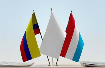 Flags of Colombia and Luxembourg with a white flag in the middle