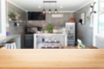 Selected focus empty brown wooden table and Coffee shop or restaurant blur background with bokeh image. for your photomontage or product display.