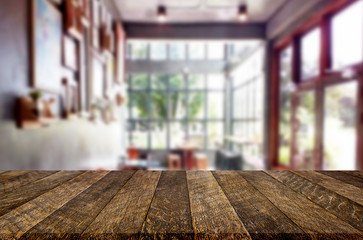 Selected focus empty brown wooden table and Coffee shop or restaurant blur background with bokeh image. for your photomontage or product display.