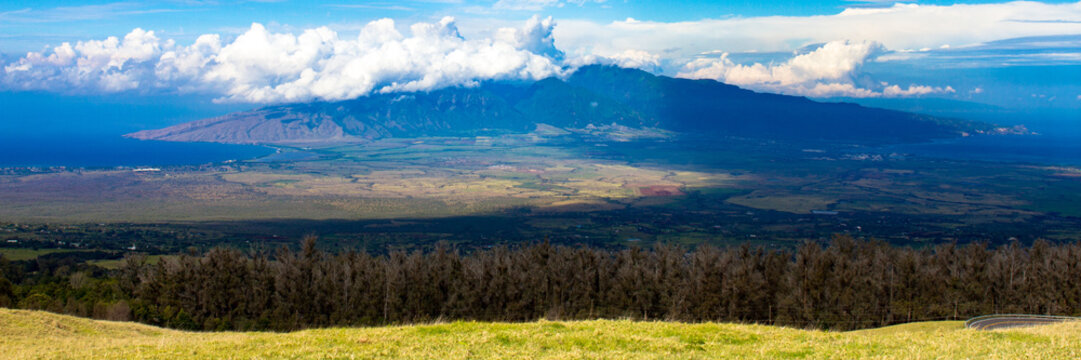 Grand panorama of Kahului Bay on the right, Maalaea Bay on the left, and Puu Kukui, the smaller volcano on the island of Maui in Hawaii, as seen from Haleakala, the larger volcano on Maui