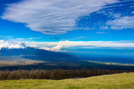 Kahului Bay and Puu Kukui, the cloud-shrouded volcano on the north end of the island of Maui in Hawaii, photographed from Haleakala, the other volcano on the island